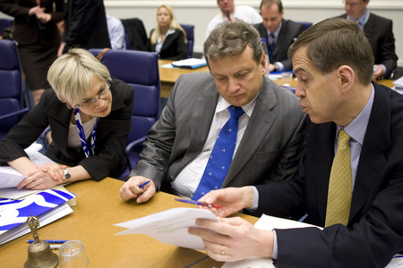 Slovenian Minister Iztok Jarc is talking with staff before the Council