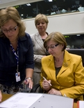 Minister Marjeta Cotman signing the documents prior to the meeting