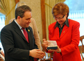 French Minister of Labour, Social Affairs and Solidarity Xavier Bertrand accepting a gift from Slovenian Minister Marjeta Cotman